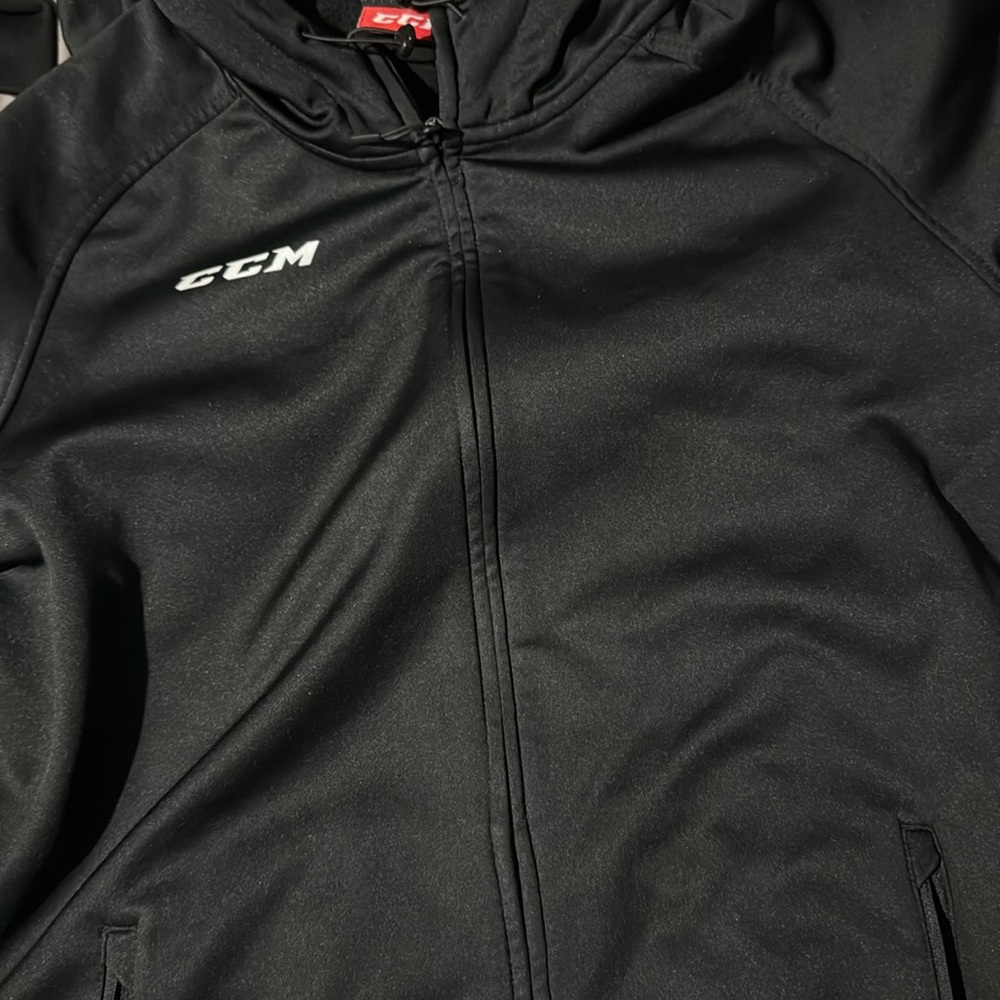 Black CCM zip up sweater size US Large, brand new
